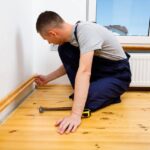 Technician Installing Skirting Boards in Home