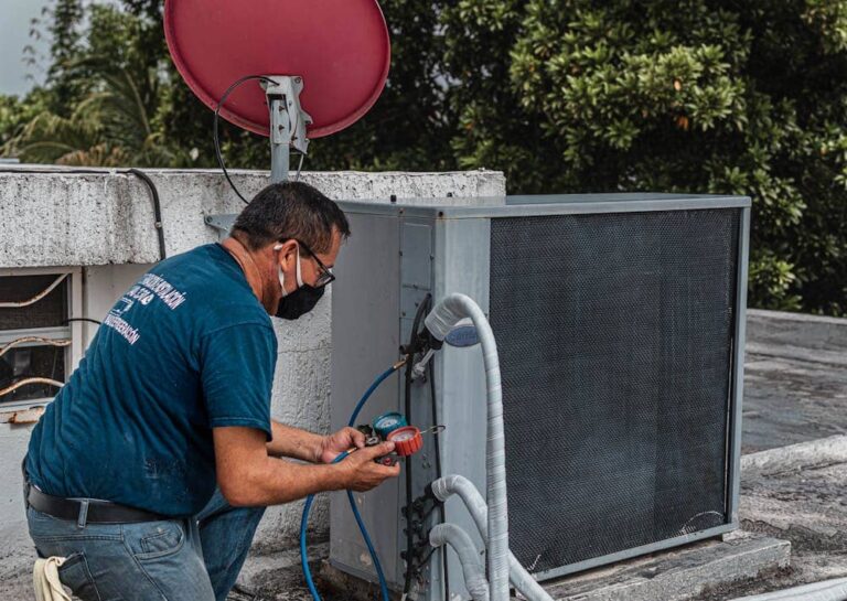 Technician servicing an HVAC system for improved energy efficiency and indoor comfort.