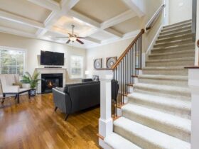 Ceiling fan running in a bright living room with air conditioner unit, improving air circulation and cooling efficiency.